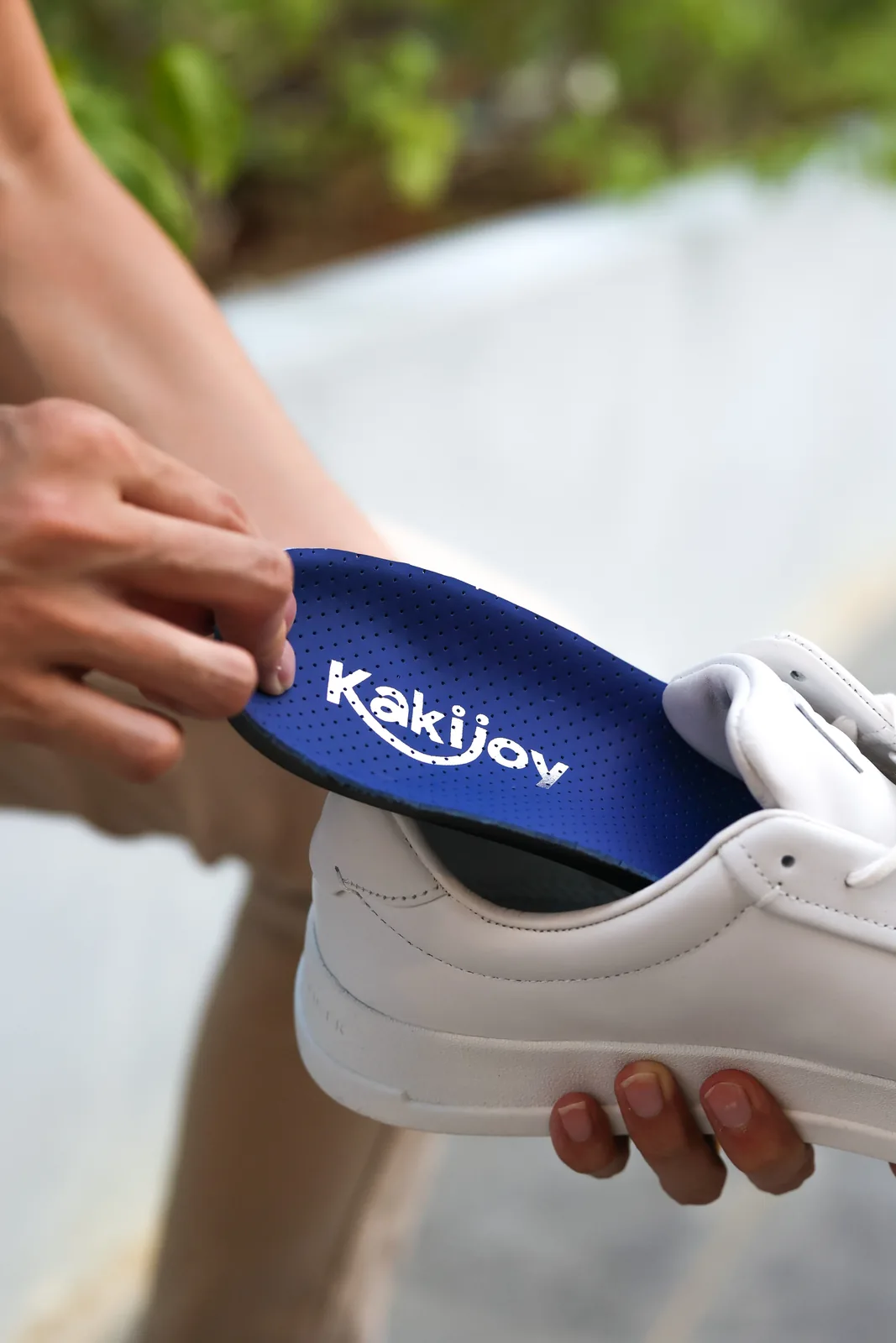 A pair of KakiJoy custom orthotic insoles, handmade with gold branding